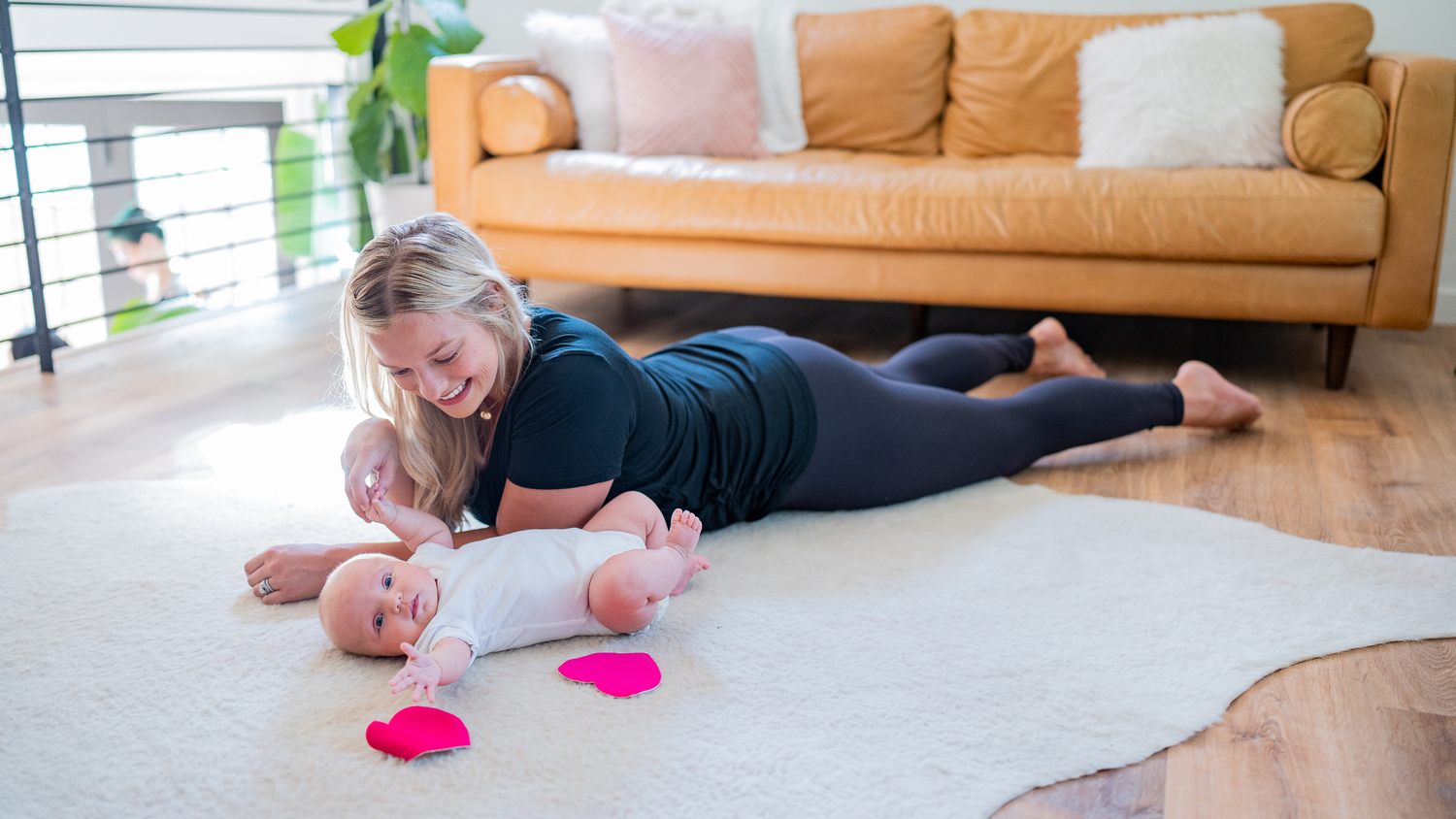 woman and baby laying on the ground with bamboobies pads